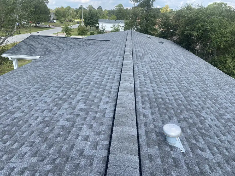 Completed gray shingle roof viewed from the ridge